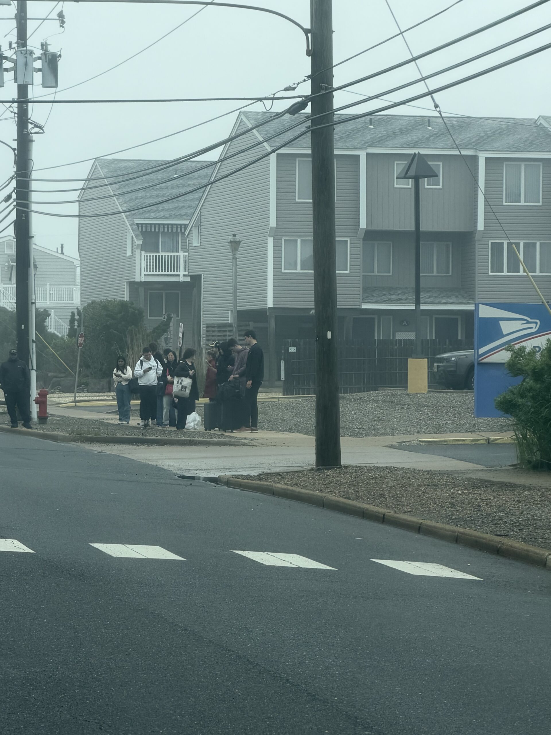 People waiting for the northbound LBI bus to New York at the Brant Beach Post Office stop