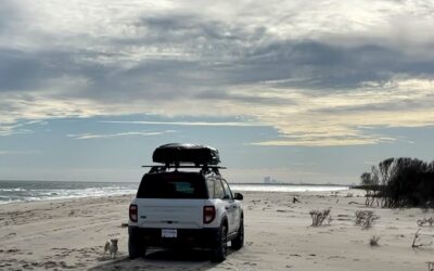 a photo of an off road vehicle on beach front