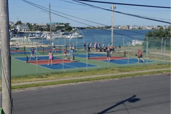 Players enjoy the action at the island's newest courts located in Surf City | Image by Karl Lombel