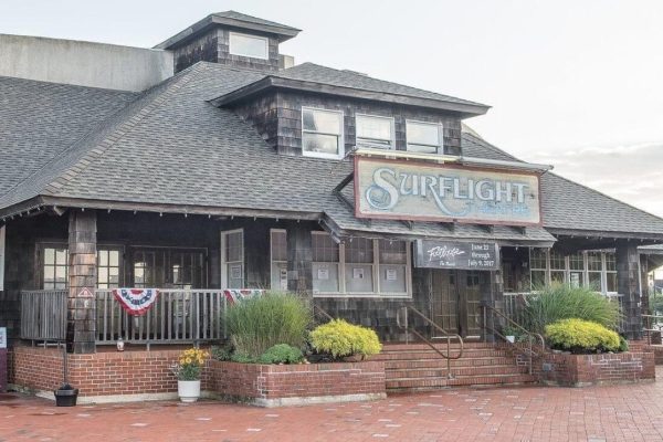 an exterior view of Surf Light Theatre with plants and steps inside the building