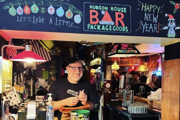 a man behind a bar taking orders